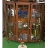 An oak demi-lune display cabinet