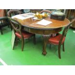 An Edwardian mahogany extending dining table with carved cabriole legs