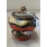 An oriental mottled pottery lidded pot applied monkeys