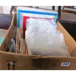 A box of records including Motown and Queen 78's, Beatles and other 45's