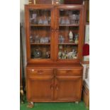 An Ercol display cabinet two glazed doors above cupboard