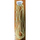 A triple pearl necklace with silver clasp