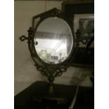 An oval freestanding mirror