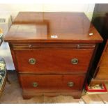 A commode converted to a two drawer chest with brushing slide