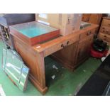 A leather top single pedestal desk