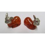 Two silver plated and amber coloured rabbits