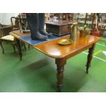 A Victorian mahogany extending dining table pull out action with interleaf