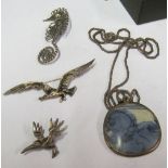 A silver chain with pendant, seahorse brooch, seagull brooch and another bird brooch
