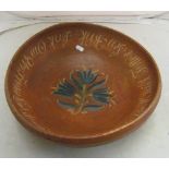 A German treen bowl with central floral design and script around border (edges slightly repaired)