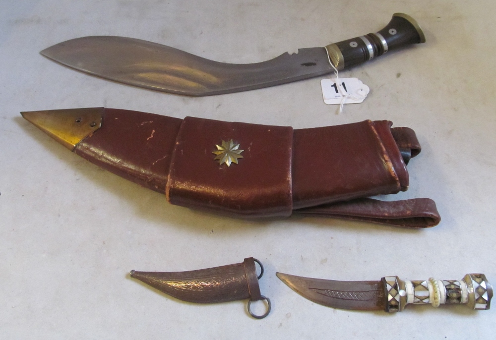 A dagger in a leather holster signed military with two small daggers and a small mother of pearl - Image 2 of 4