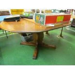 An Ercol extending drawleaf dining table on central coloumn support