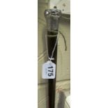 A walking cane with silver top