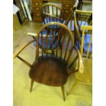 A pair of stick back Ercol chairs and a carver chairs and a similar high back chair