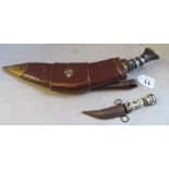 A dagger in a leather holster signed military with two small daggers and a small mother of pearl