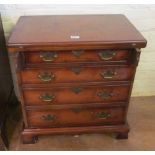 A small walnut chest of four graduated drawers with hinged top