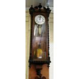 A 19th Century eight day wall clock, turned pillars