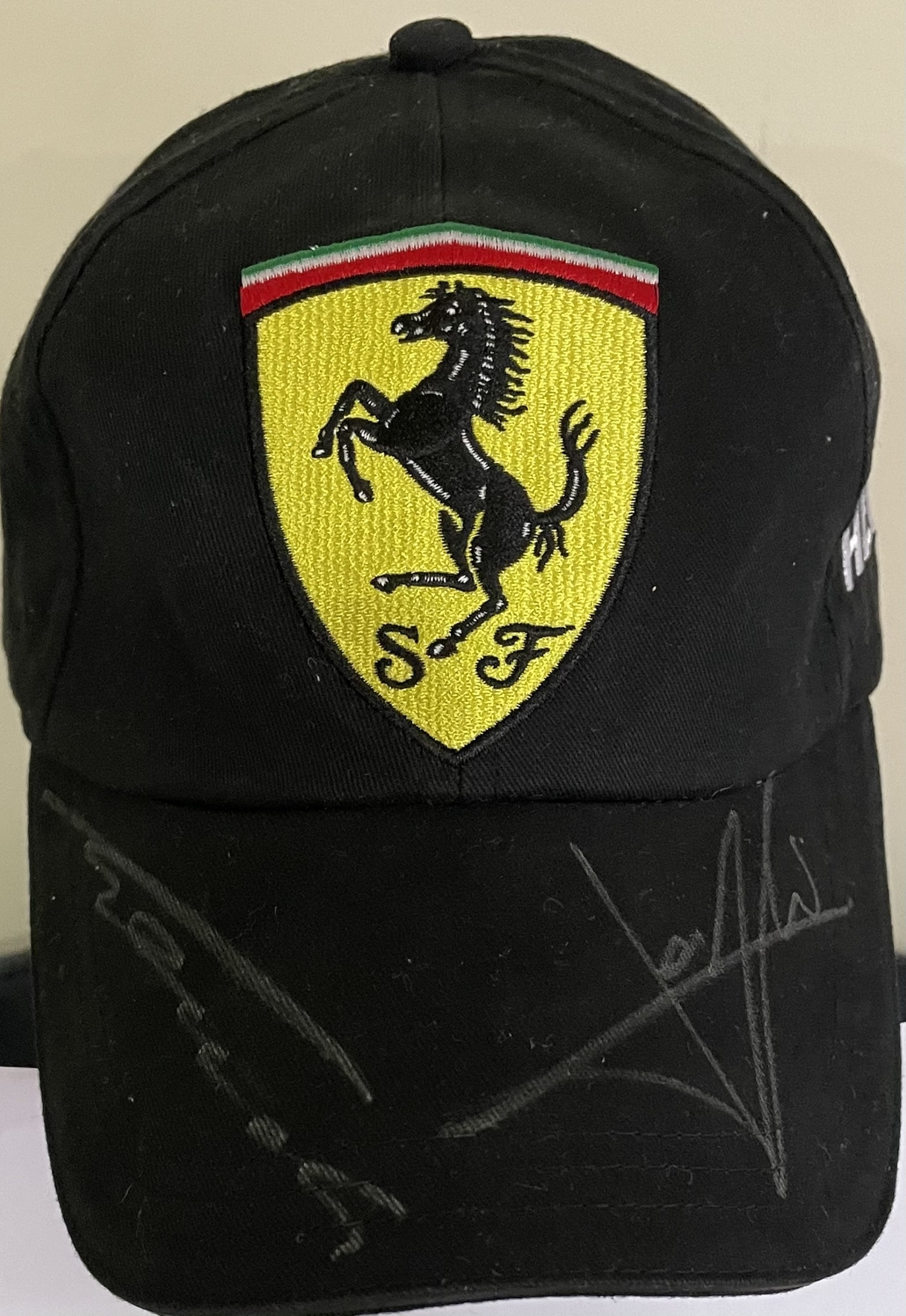 FORMULA ONE: An official souvenir Scuderia Ferrari black baseball-style cap,