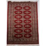 AN ORIENTAL HANDWOVEN RUG