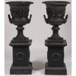 A LARGE PAIR OF IRON GARDEN URNS