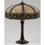 A HANDEL BRONZE & SLAG GLASS TABLE LAMP