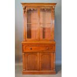 A William IV Mahogany Secretaire Bookcase, the moulded cornice above two carved and glazed doors,