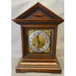 An Early 20th Century Oak Mantel Clock, the brass dial with Arabic numerals and two train