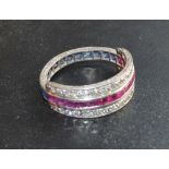 A White Gold Night and Day Ring set with a band of rubies and sapphires and two bands of diamonds