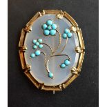 A Victorian Oval Brooch with chalcedony and turquoise flower heads within an oval gold mount, 4.5