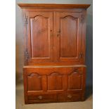 A George II Oak Bacon Cupboard, the moulded cornice above two arched moulded doors, the lower