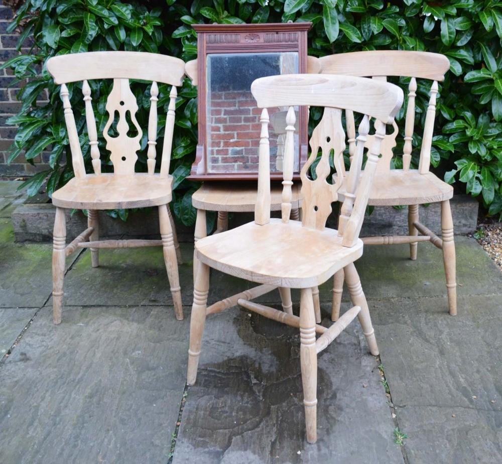 A Set of Four Pine Side Chairs, each with a pierced splat and spindle back with panel seat raised