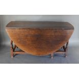 An 18th Century Oak Oval Gateleg Dining Table with turned legs and stretchers, 150 x 174cm