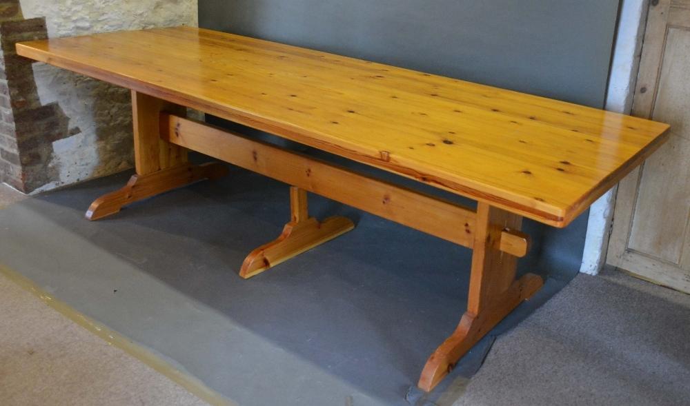 A Large Pine Refectory Style Dining Table, the plank top above three supports with stretcher,