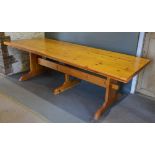 A Large Pine Refectory Style Dining Table, the plank top above three supports with stretcher,