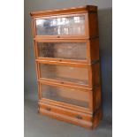A Globe Wernicke Oak Four Section Bookcase with drawer in base