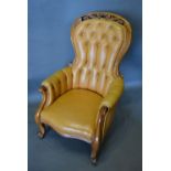 A Victorian Mahogany Buttoned Leather Upholstered Drawing Room Armchair, the partly pierced back