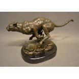 A Patinated Bronze Model in the Form of a Cheetah upon oval variegated marble plinth, 19cm tall