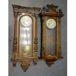 A Victorian Walnut Vienna Wall Clock, the enamel dial with Roman numerals and with weight driven