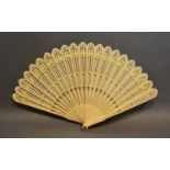 An Early 19th Century Carved Brise Fan of pierced form, 15.5cm long