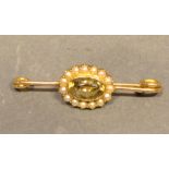 A Gold Bar Brooch set with an oval citrine surrounded by pearls