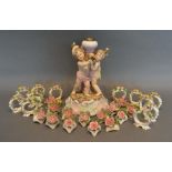 A German Porcelain Table Centre in the form of putti, together with a collection of German porcelain