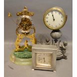 A Tudric Beaten Pewter Clock of square form, together with a 20th century brass skeleton clock and a