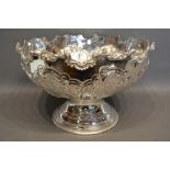 A Silver Plated Large Punch Bowl embossed with scrolls and foliage upon a circular pedestal base,