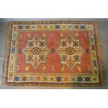 A North West Persian Style Woollen Rug with two medallions within an allover design upon a