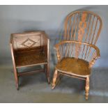 A 19th Century Elm Windsor Rocking Armchair with a pierced splat and spindle back above a panel seat