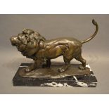 A Patinated Bronze Model in the Form of a Lion upon rectangular variegated marble plinth, 33cm long