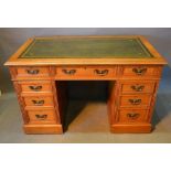 A Late Victorian Walnut Twin Pedestal Desk, the green tooled leather inset top above nine drawers