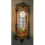 A Victorian Walnut Vienna Wall Clock, the enamel dial with Roman numerals and with weight driven