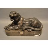 A Patinated Bronze Model in the Form of a Tiger upon rectangular variegated marble plinth, 31cm long