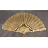 An 18th Century Ivory Fan, the gauze leaf with gold sequins with gilded sticks and guards, 19cm long