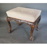 A 19th Century Rectangular Stool with an upholstered seat above a carved frieze raised upon cabriole